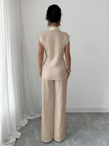 Back view of an elegant beige short-sleeve shirt and straight-leg trousers two-piece set.