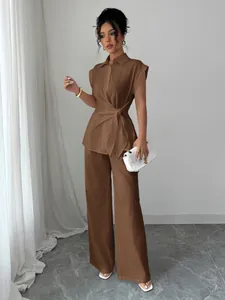 Elegant brown two-piece set featuring a tie-waist short sleeve shirt and straight pants.