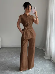 Elegant brown two-piece set featuring short-sleeve tie-waist shirt and wide-leg pants