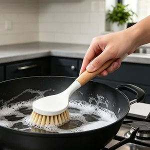 Wooden handle kitchen cleaning brush for dishes and pots in a modern kitchen setting