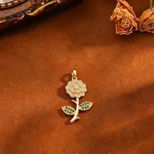 Close-up of 18k gold plated rose pendant with micro-paved green and clear cubic zirconia