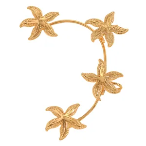 Dettaglio ravvicinato di un ear cuff dorato stile oceano con stelle marine