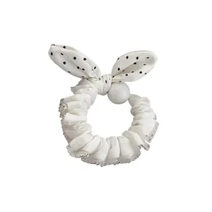 Fresh white polka dot bow scrunchie featuring a pearl and silver lace edge trim accessory
