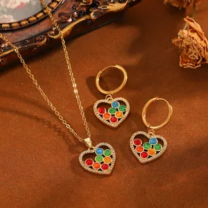 Vue détaillée de parure bijoux cœur en acier doré avec de petites perles multicolores