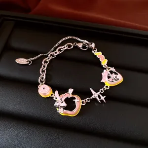 Detailed view of a silver retro charm bracelet with pink enamel rabbit and star charms.
