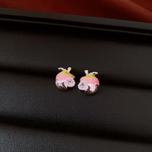 Close-up detail view of vintage style pink fruit earrings with sparkling zircon inlay decoration