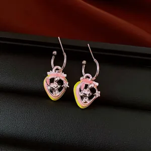 Close-up detail of strawberry hoop earrings featuring a cute bunny and zircon stones