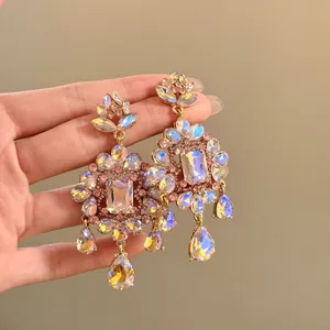 Detailed macro view of ornate vintage floral earrings encrusted with iridescent crystals