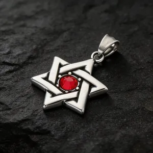 Close-up of retro hexagram pendant with a central red gemstone on stone surface.