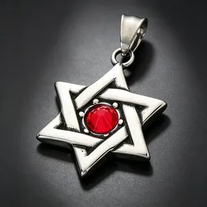 Close-up of vintage stainless steel Star of David pendant with a red gemstone detail.