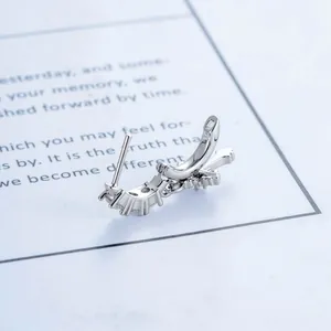 Silver fleur-de-lis cross stud earring with vintage millennium aesthetic