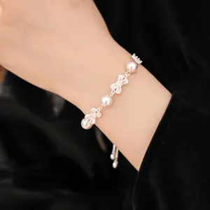 Detail shot of elegant bowknot pearl bracelet with zircons worn on wrist