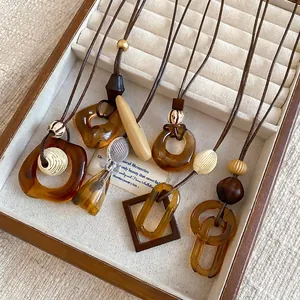 Vintage style resin hollow pendant necklace in amber brown tones for women's fashion