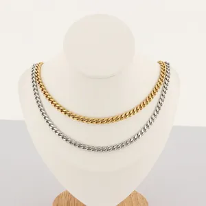 Detail of gold and silver stainless steel Cuban link necklaces on a white neck display.