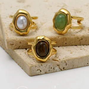 Detailed view of gold-plated stainless steel open rings with pearl and natural stones.