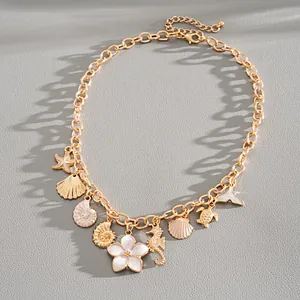 Gold ocean-themed necklace featuring white enamel starfish shell and flower charms
