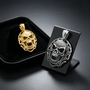 Gros plan de pendentifs tête de mort or et argent avec bordure en flamme.