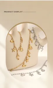 Detail of gold and silver stainless steel ocean charm jewelry with starfish and octopus.