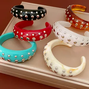 Collectie dikke hars armbanden met zilveren klinknagels in zes verschillende kleuren.