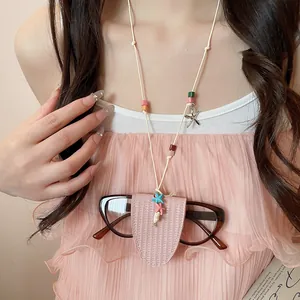 Detail of pink leather glasses holder necklace with colorful beads and starfish charms.