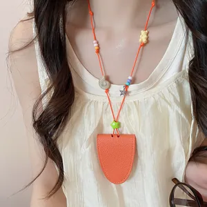 Close-up of orange leather necklace glasses holder with cute colorful charms