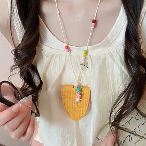 Detail showing a yellow leather neck-hanging glasses holder with vibrant color beads.