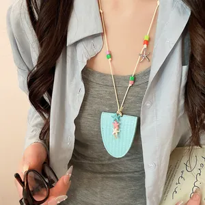 Dopamine style light blue leather necklace with colorful star charms shown on a model