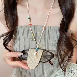 Detail of a colorful leather necklace glasses holder featuring star charms and beads.