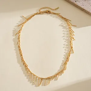 Elegant gold metal fringe necklace with textured copper rod tassels and adjustable chain