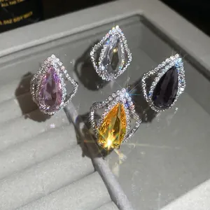 Luxury teardrop colored gemstone rings with full pave diamond setting, elegant jewelry.