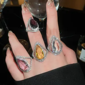 Luxurious teardrop-shaped rings with sparkling crystals and colored gems for high-end style.