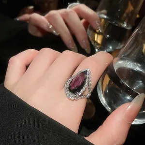 Elegant pear-shaped purple gemstone ring with sparkling pavé diamonds for women