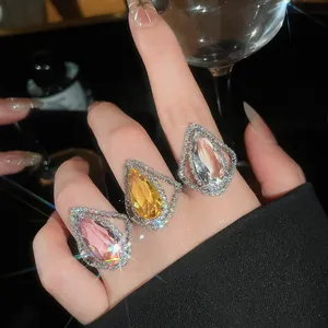 Close-up detail of luxurious waterdrop-shaped rings with sparkling colorful gemstones