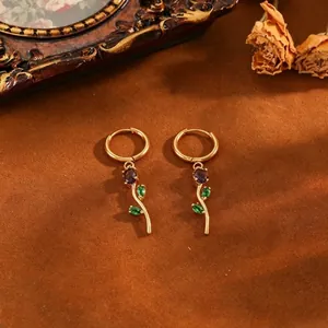 Elegant gold-plated stainless steel tulip earrings with purple stone and green leaf detail.