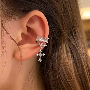 Close-up detail of copper cross ear cuff featuring elegant square-cut cubic zirconia