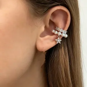 Detailed close-up of a stylish pearl and zircon ear cuff with a dangling star charm