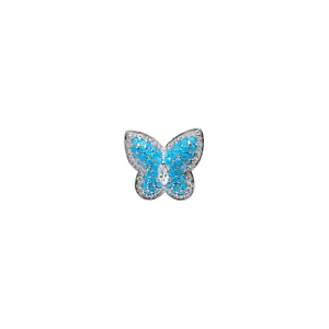 Elegant butterfly ear cuff earring with blue stones and sparkling zircons on white backdrop