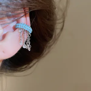 Detailed view of elegant blue enamel ear cuff with sparkling zircon tassel chains