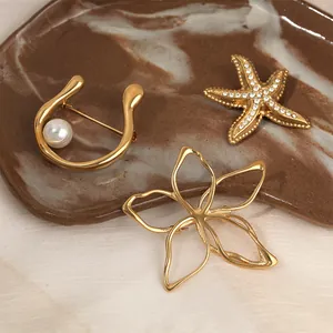 Elegant gold-plated stainless steel brooch set featuring starfish and hollow flower designs.