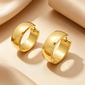 Close-up view of minimalist gold-plated stainless steel chunky hoop earrings with a polished finish