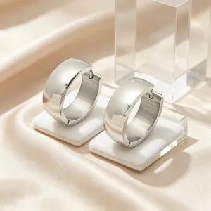 Close-up of minimalist stainless steel hoop earrings with glossy silver finish