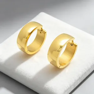 Macro view of minimalist polished gold stainless steel hoop earrings for daily wear