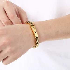 Close-up detail of a gold stainless steel Byzantine Emperor chain bracelet on wrist