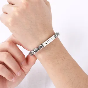 Close-up of a silver Byzantine chain bracelet on a wrist, showing high-quality steel texture.