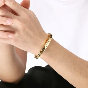 Close-up of a gold-plated stainless steel Byzantine chain bracelet on a male wrist.