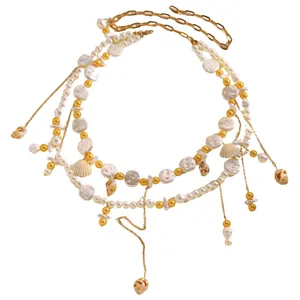 Detail view of layered seashell and pearl tassels on a gold-tone resort waist chain
