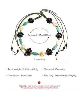 Detailed view of boho ceramic beaded waist chain with wood flower accents and green cord