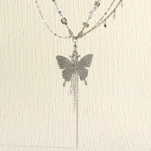 Close-up detail of silver multi-layer butterfly waist chain with crystals and pearls.
