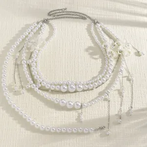 Detailed view of an exquisite multi-layer pearl waist chain with seashell and tassel