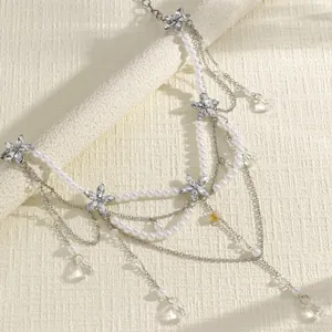Close-up detail of bohemian multi-layer pearl waist chain with sparkling crystal flowers